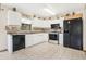 Kitchen with white cabinets, black appliances, and tile flooring at 5920 Norvale Ct, Orlando, FL 32808