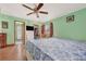 Bedroom with a white bed frame, wooden floors, and access to a bathroom at 5920 Norvale Ct, Orlando, FL 32808
