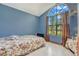 Cozy bedroom with floral bedding and a large window at 5920 Norvale Ct, Orlando, FL 32808