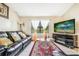 Living Room features a black leather sofa, coffee table, and fireplace at 5920 Norvale Ct, Orlando, FL 32808