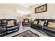 Living Room with black leather reclining sofas and a coffee table at 5920 Norvale Ct, Orlando, FL 32808