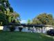 Ranch-style home with a large yard and mature trees at 223 Hope Cir, Orlando, FL 32811