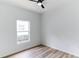 Bright bedroom with wood-look floors and a window at 316 Shelbourne Loop, Kissimmee, FL 34759