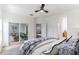 Main bedroom with sliding glass doors to patio and stylish bedding at 316 Shelbourne Loop, Kissimmee, FL 34759