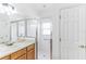 Bathroom with walk-in shower, grab bar, and wood cabinets at 316 Shelbourne Loop, Kissimmee, FL 34759