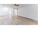 Spacious living room featuring light wood-look floors and a ceiling fan at 316 Shelbourne Loop, Kissimmee, FL 34759