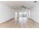 Large living area with sliding doors to a patio and wood-look floors at 316 Shelbourne Loop, Kissimmee, FL 34759