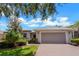 Front view of a single-story house with a two-car garage at 316 Shelbourne Loop, Kissimmee, FL 34759