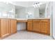 Double vanity bathroom with wood cabinets and large mirrors at 316 Shelbourne Loop, Kissimmee, FL 34759