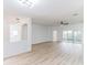 Open living area with kitchen views, wood floors, and sliding glass doors at 316 Shelbourne Loop, Kissimmee, FL 34759