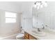 Clean bathroom with a bathtub, sink, and wood cabinets at 316 Shelbourne Loop, Kissimmee, FL 34759