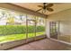 Bright screened patio with brick flooring and access to backyard at 316 Shelbourne Loop, Kissimmee, FL 34759