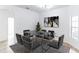 Dining room with modern glass table and dark chairs at 316 Shelbourne Loop, Kissimmee, FL 34759