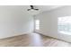 Simple bedroom with wood-look floors and two windows at 316 Shelbourne Loop, Kissimmee, FL 34759