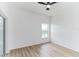Simple bedroom with wood-look floors and a window at 316 Shelbourne Loop, Kissimmee, FL 34759