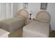 Guest bedroom with twin beds and neutral decor at 346 Kildrummy Dr, Davenport, FL 33896