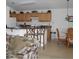 Kitchen with light wood cabinets, breakfast bar, and adjacent dining area at 346 Kildrummy Dr, Davenport, FL 33896