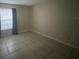 Spacious bedroom with tile floors and window at 1073 S Hiawassee Rd # 1018, Orlando, FL 32835