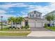 Two-story house with a two-car garage, landscaping, and palm trees at 1839 Good Neighbor Loop, Kissimmee, FL 34744