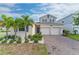 Two-story house with a two-car garage, landscaping, and palm trees at 1839 Good Neighbor Loop, Kissimmee, FL 34744