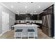 Modern kitchen with dark cabinetry, white countertops, and island at 1839 Good Neighbor Loop, Kissimmee, FL 34744