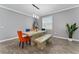 Elegant dining room featuring a rustic table and stylish chairs at 1839 Good Neighbor Loop, Kissimmee, FL 34744