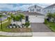 Two-story house with a two-car garage, landscaping, and palm trees at 1839 Good Neighbor Loop, Kissimmee, FL 34744