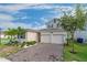 Two-story house with a two-car garage, landscaping, and palm trees at 1839 Good Neighbor Loop, Kissimmee, FL 34744