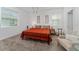Bright bedroom with orange comforter and modern lighting at 1839 Good Neighbor Loop, Kissimmee, FL 34744