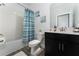 Clean bathroom with tub, shower, and dark vanity at 1839 Good Neighbor Loop, Kissimmee, FL 34744