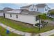 Rear view of a two-story house with solar panels and landscaping at 1839 Good Neighbor Loop, Kissimmee, FL 34744