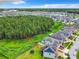 Aerial view of house, backyard, and surrounding community at 2404 Riverbank Cv, Kissimmee, FL 34741