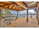 Covered waterfront dock with seating area and lake views at 279 Rippling Ln, Winter Park, FL 32789