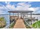 Covered dock with boat lift and seating area overlooking the lake at 279 Rippling Ln, Winter Park, FL 32789