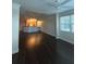 Open living room showcasing dark hardwood floors at 6413 Astor Village Ave # 303, Orlando, FL 32835