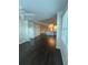 Open living room showcasing dark hardwood floors at 6413 Astor Village Ave # 303, Orlando, FL 32835