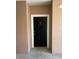 Modern condo front door with black finish and white trim at 6413 Astor Village Ave # 303, Orlando, FL 32835