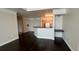 Dark hardwood floors in open living room with kitchen bar at 6413 Astor Village Ave # 303, Orlando, FL 32835