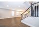 Bright living room with wood-look tile flooring, and a view of the kitchen and staircase at 12737 Brodlove Ln, Winter Garden, FL 34787