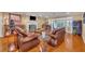 Spacious living room with hardwood floors, fireplace, and comfortable leather seating at 279 Rippling Ln, Winter Park, FL 32789