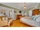 Main bedroom with hardwood floors, large windows, and an ensuite at 279 Rippling Ln, Winter Park, FL 32789