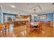 Open dining room and kitchen with hardwood floors and a large wooden table at 279 Rippling Ln, Winter Park, FL 32789