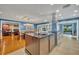 Open concept kitchen island with breakfast bar and stainless steel appliances at 279 Rippling Ln, Winter Park, FL 32789
