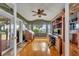 Bright home office with built-in wooden shelving and hardwood floors at 279 Rippling Ln, Winter Park, FL 32789