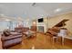 Spacious living room with hardwood floors and a fireplace at 279 Rippling Ln, Winter Park, FL 32789