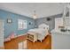 Serene bedroom with hardwood floors and white furniture at 279 Rippling Ln, Winter Park, FL 32789