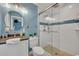 Modern bathroom with a walk-in shower and round mirror at 279 Rippling Ln, Winter Park, FL 32789