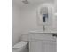 Small bathroom with white vanity and wicker mirror at 1994 Kenaston Rd # 1994, Maitland, FL 32751