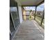 Private balcony with wood-look tile flooring, offering an outdoor space at 1000 Lake Of The Woods Blvd # C205, Fern Park, FL 32730