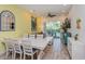 Casual dining area with white table and chairs, adjacent to living room at 8014 Knee Deep Rd, Kissimmee, FL 34747